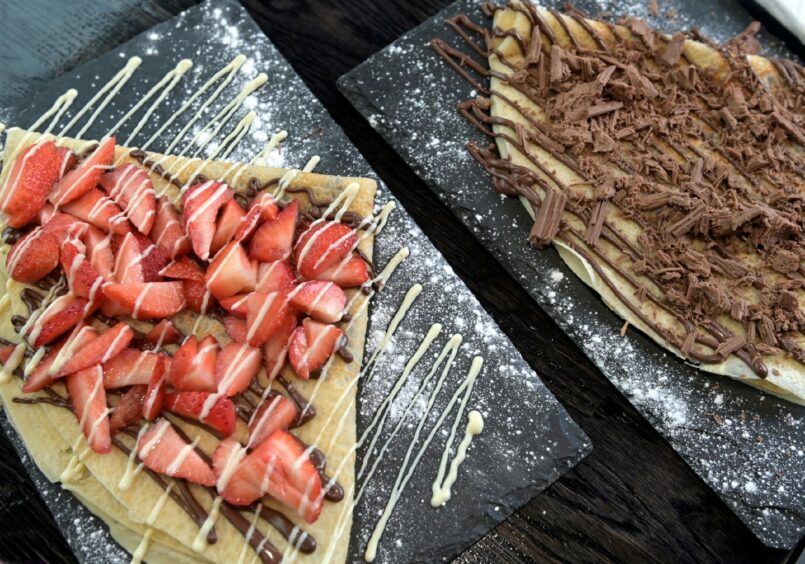 A chocolate and strawberry crepe next to a chocolate flake crepe from Shakes 'n' Cakes