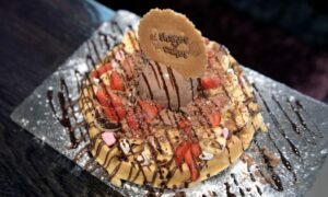 A shakes n cakes chocolate, banana and strawberry waffle with marshmallows and a scoop of chocolate ice cream