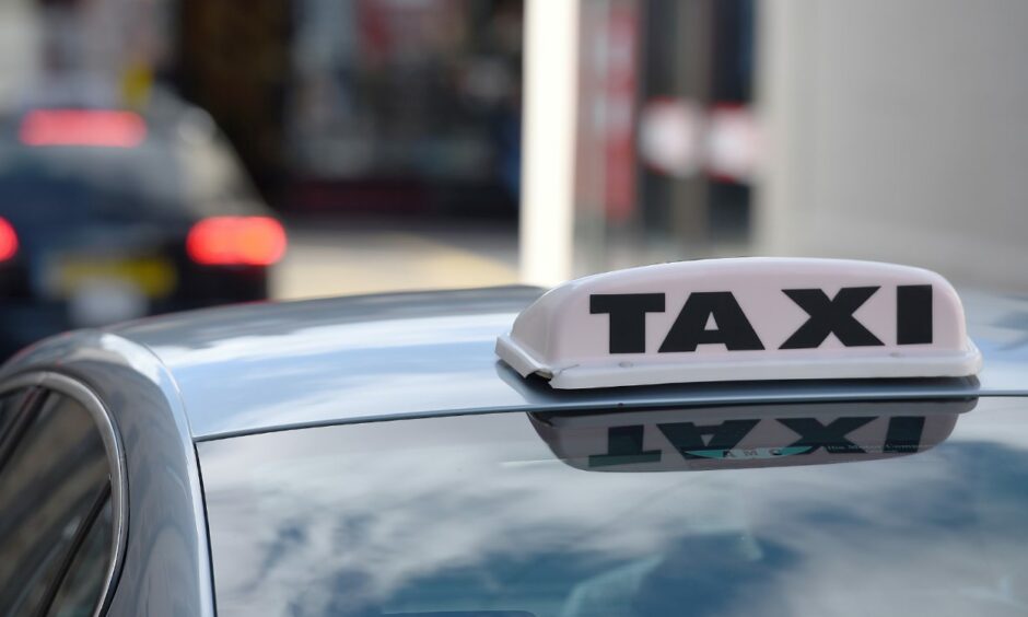 Taxi sign on the top of a cab in Inverness, follwoing one woman being banned for racism.