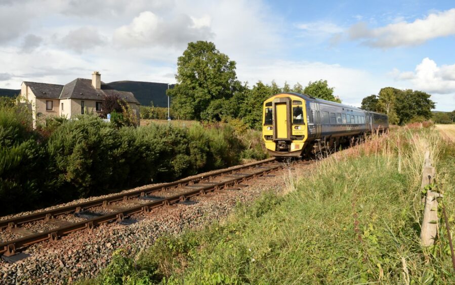 A Scotrail train for the far north passes through Evanton.