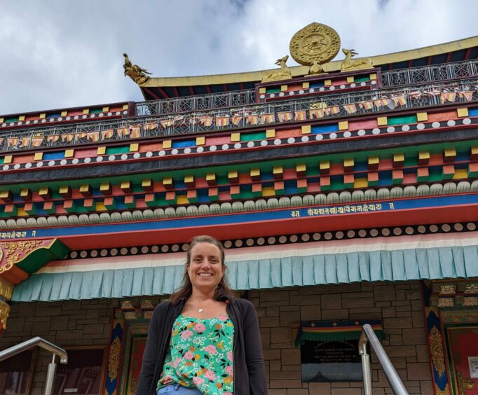 Rebecca Lowson outside the temple at Kagyu Samye Ling Monastery in July 202