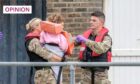A child is carried after disembarking a Border Force Hurricane rescue boat in Dover (Image: Stuart Brock/EPA-EFE/Shutterstock)