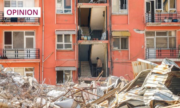 A badly damaged apartment block next to a destroyed building, following the earthquake in Samandag, southern Turkey (Image: Emrah Gurel/AP/Shutterstock)