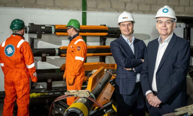 DeltaTek CEO and founder Tristam Horn and Expro chief operating officer Alistair Geddes, l-r in the suits, on a workshop visit. Image: Expro