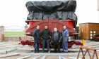 Alfred Codona, Jack Codona, Andy Bates and Raymond Eddie next to waltzers during refurbishment. Image: Codona's