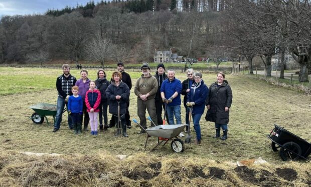 A group of volunteers breaking ground on the new Aberlour Community Garden. Image: Andrew Kimmitt.