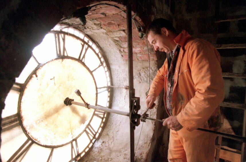 Work being carried behind the Holburn West Church clock face in 1999. A phone mast was being fitted in the tower. Image: Kami Thomson/DC Thomson.