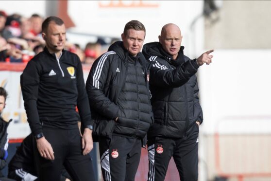 Barry Robson and Steve Agnew in the 3-0 defeat of Hearts. Image: Shutterstock