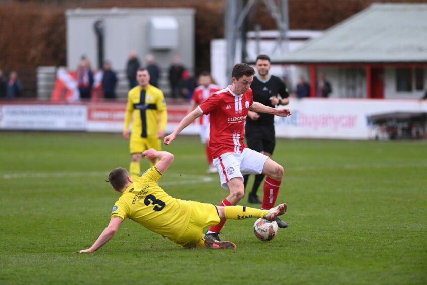 Brechin City midfielder Fraser Macleod escapes the challenge of Wick Academy player-boss Gary Manson. Image: Darrell Benns/DC Thomson