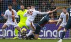 Motherwell's Callum Butcher brings down Ross County's Alex Iacovitti (R) but the penalty award was later rescinded following a VAR check. Image: SNS.