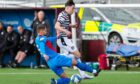 Queen's Park's Grant Savoury is tackled by Inverness' Robbie Deas. Image: SNS