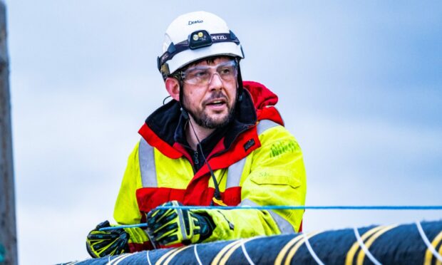 An NKT Victoria crew member checks the HVDC cable.