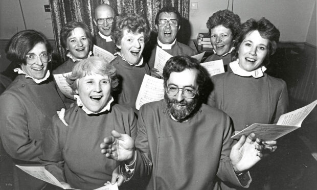 1986 - The choir-a-gram voices of Queen’s Cross Church with musical director Geoffrey Atkinson, front.