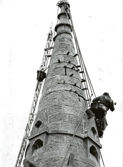 1988 - A workman finishes repair work on the steeple spire at Queen’s Cross Church.