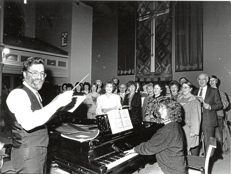 1989 - The Queen’s Cross Charity Chorus rehearse with conductor Geoffrey Atkinson a performance of The African Sanctus.