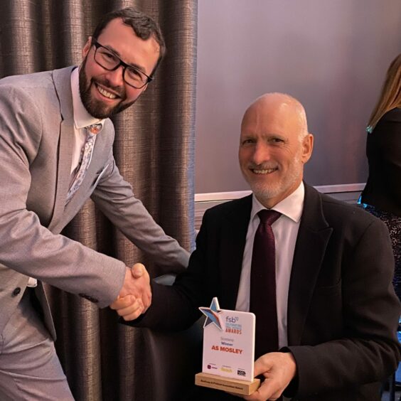 Andrew Mosley (right), with his Business and Product Innovation Award, being congratulated by Mike Duncan, FSB. Supplied by FSB.