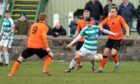 Buckie's Max Barry tries to wriggle free of Rothes' attentions. Image: Jasperimage