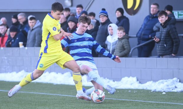 Max Barry, left, of Buckie Thistle battles with Banks o' Dee's Ramsay Davidson. Photos by Darrell Benns.