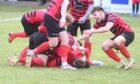 Inverurie Locos' Sam Burnett is mobbed after scoring his side's second goal. Image: Chris Sumner/DC Thomson