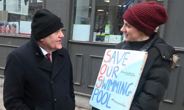 Aberdeen Labour leader Barney Crockett with leading Bucksburn pool campaigner Kirsty Fraser. His party joined the demonstration in support of keeping the facility open - despite voting for the same £687,000 cut that brought about its closure. Image: Chris Sumner/DC Thomson.