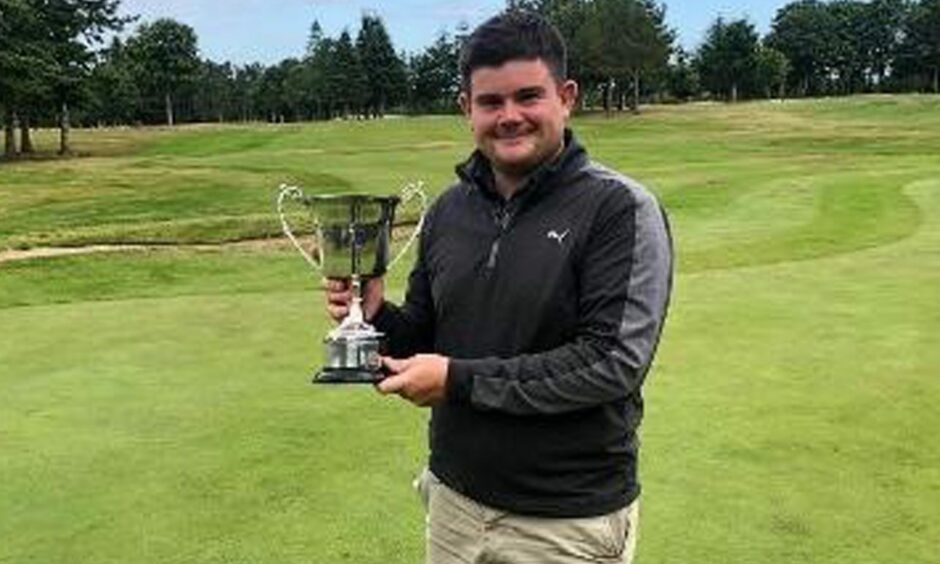 Calum Morrison of Inverurie Golf Club holding a trophy