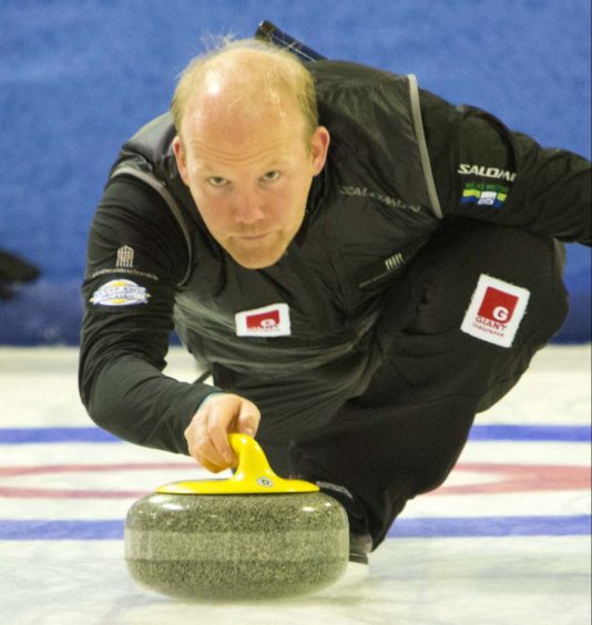 Ewan MacDonald in action while curling