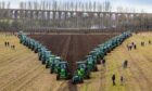 FABULOUS FURROWS: The spectacular sight of the massed tractors at the Field of Deere speed ploughing event has gone viral, with millions of views on TikTok and YouTube. Pictures by Anne MacPherson and Andrew Stevenson.