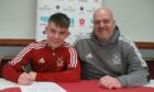 Deveronvale boss Craig Stewart with Mikey Watson signing a new deal. Image: Deveronvale FC