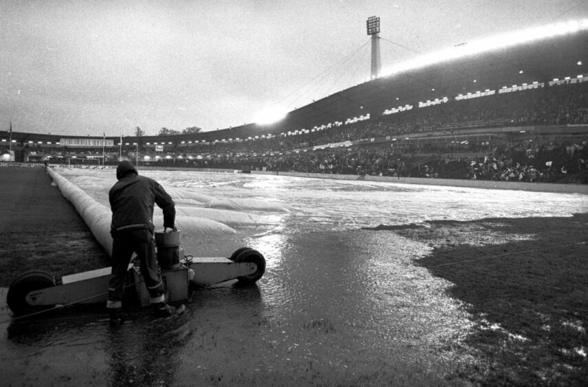 The waterlogged covering at the Ullevi Stadium in Gothenburg is removed from the pitch. Image: DCT.