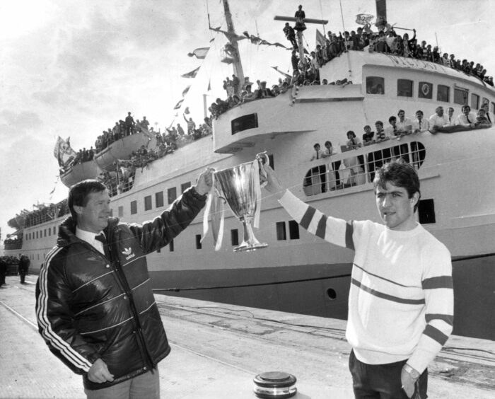 Gothenburg Heroes: Manager Alex Ferguson and Mark McGhee hold aloft the Cup Winners Cup to welcome back the Dons fans who had travelled to Gothenburg on the St Clair ferry.