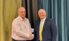 Paul Johnson, managing director of Barenburg UK, left, shaking hands with Johnny Watson of Watson Seeds.