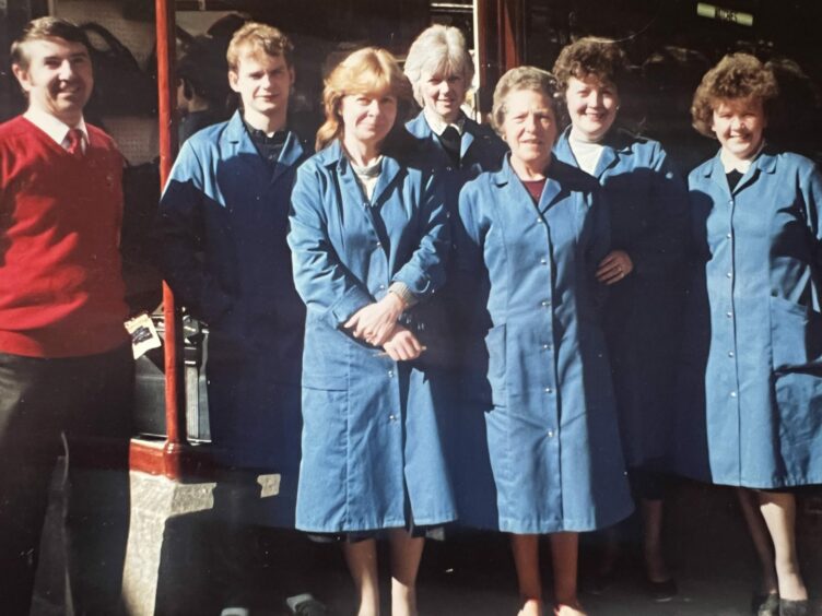 Former owner Graeme MacKenzie and staff outside the South Street store.