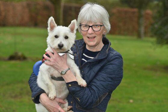 One of Mackie's of Scotland long-serving employees Lesley Skene and her dog Fergie. Image: Kenny Elrick/DC Thomson
