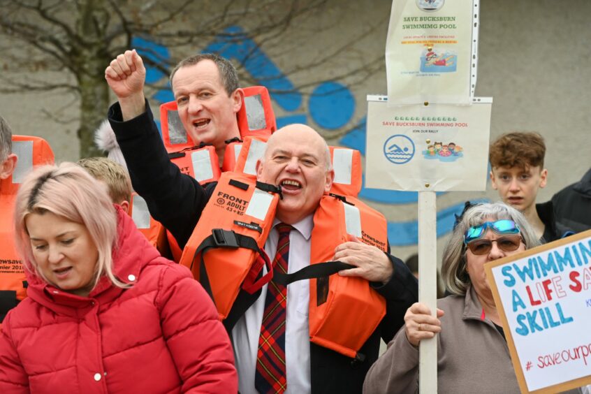 Aberdeen Labour leader Barney Crockett joined protestors at Bucksburn swimming pool - as he urged them to demand a voice at the upcoming special meeting on the unpopular council budget cuts. Image: Kenny Elrick/DC Thomson.