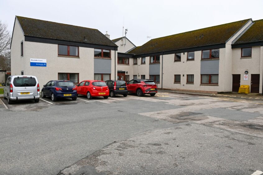 Blackhills Court sheltered housing from outside, with Aberdeenshire Council signs in view. 