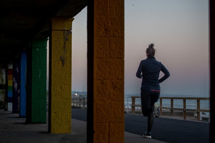 A woman running at dusk