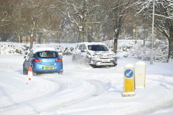 Two cars in heavy snow