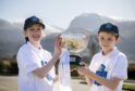 Freya and Fraser of Lochaber School made the draw for the Cottages.com MacTavish Cup 2023. Image: Camanachd Association