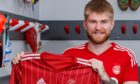 Hayden Coulson signs for the Dons. MUST CREDIT Aberdeen FC.