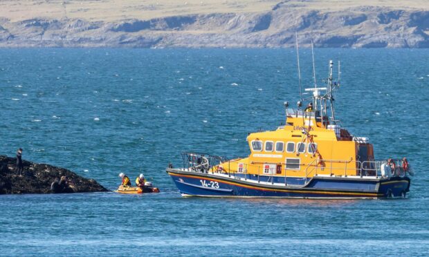 Oban lifeboat launches its daughter craft to reach the casualty on Maiden Island. Image: Stephen Lawson/RNLI