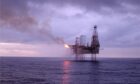 Oil rig at sea in sunset