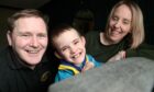 1st Elgin Beavers has been "life changing" for 7-year-old Louis Ross. He is 
 photographed with his parents Charlie and Margaret.
Image: Sandy McCook/DC Thomson