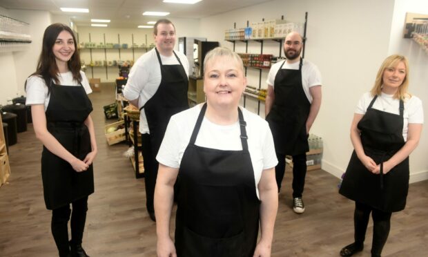 Ness Refill, owner Evelyn Elder with her five members of staff. From left to right: Jacqueline MacPherson, Mike MacDonald, Emilio Gascon and Debbie MacKenzie. Image: Sandy McCook/ DC Thomson