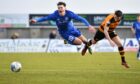 Peterhead's Kieran Shanks is sent flying by Alloa's Kevin Cawley. Image: Duncan Brown.