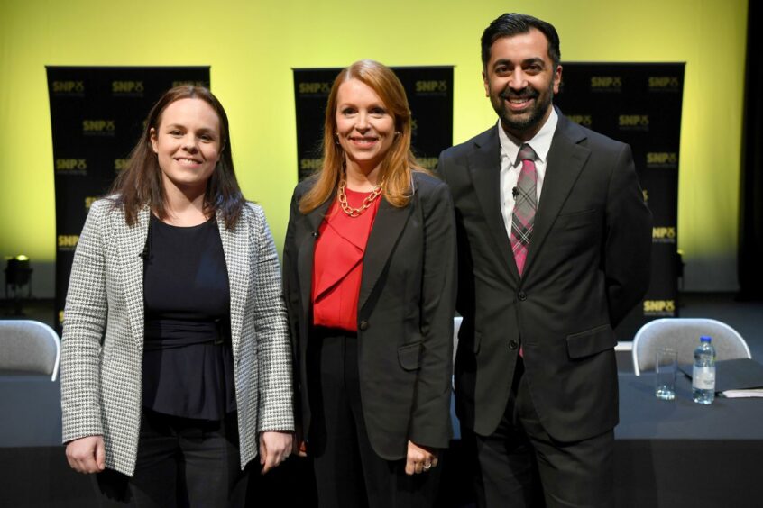 SNP leadership candidites Kate Forbes, Ash Regan and Humza Yousaf standing in a line and smiling at the camera