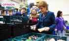 First Minister Nicola Sturgeon visits a foodbank in 2018 (Image: Andy Buchanan/PA)