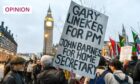 A protester holds a placard in support of football pundit Gary Lineker (Image: Mike Ruane/SOPA Images/Shutterstock)