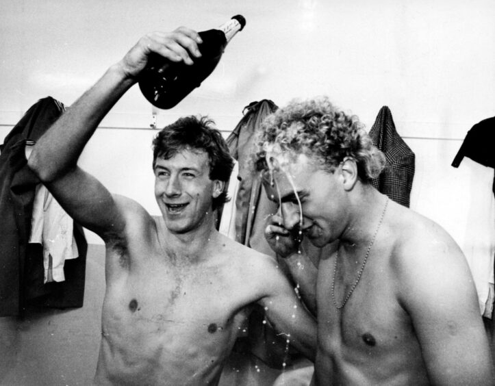 Neil Simpson pours champagne over Neale Cooper's head during the league title celebrations in 1985. Image: DC Thomson.