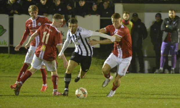 Fraserburgh's Ryan Sargent, second from right, tries to get away from Kevin McHattie of Brechin, right. Pictures by Wullie Marr