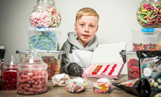 Sol Murdoch with some of the sweets he sells. Image: Wullie Marr / DC Thomson.